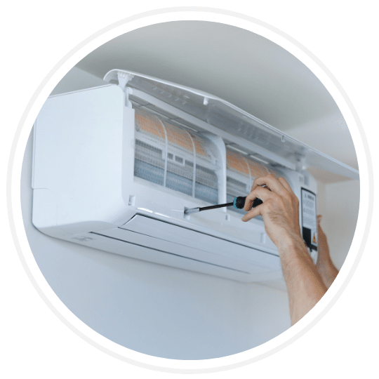 hands of technician repairing residential air conditioner unit in summerwood